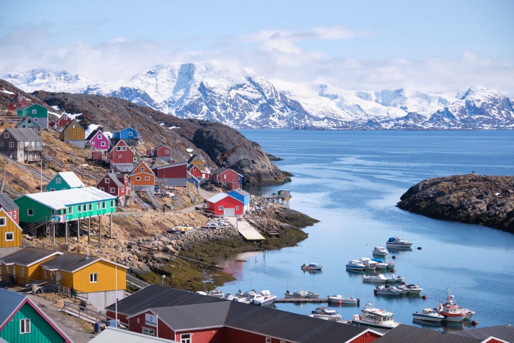 Overlooking the colourful houses of Sarfannguit and the tall mountains beyond - West Greenland
