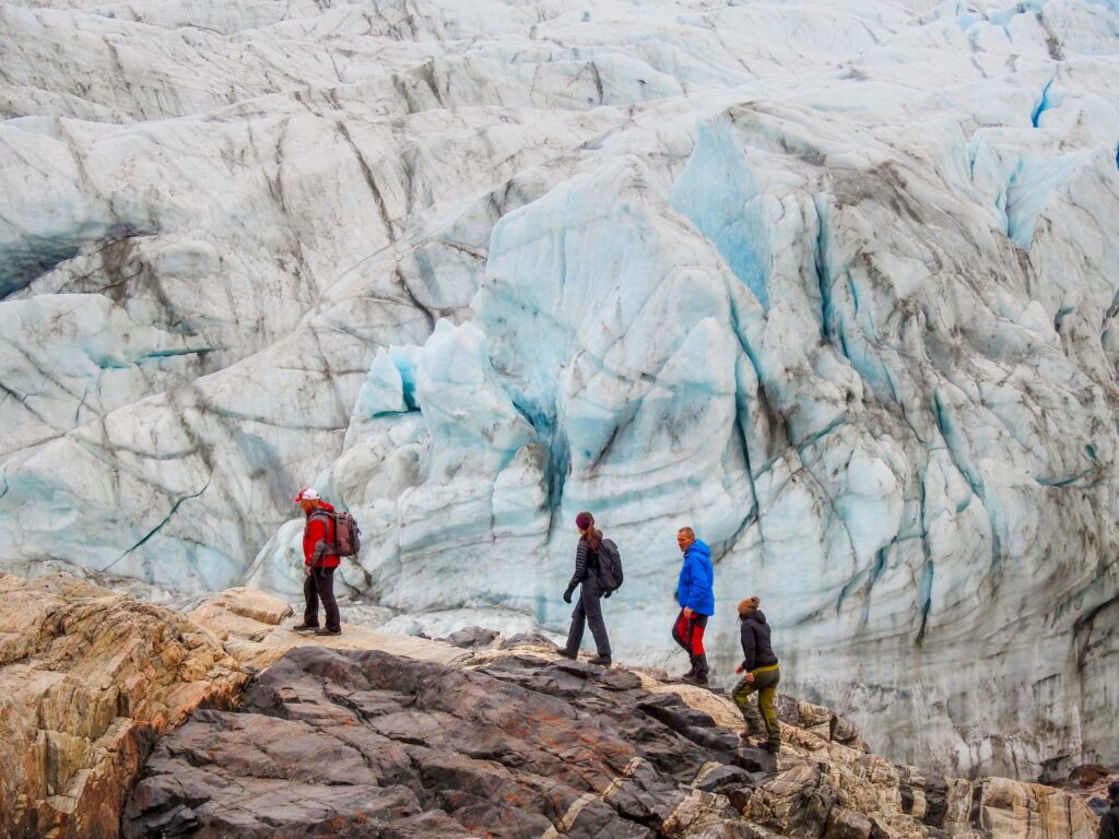 Visitors in front of the enormous ice face of the Russell Glacier - Kangerlussuaq, Greenland