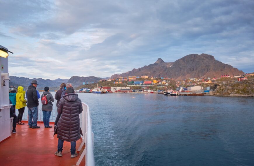 Passengers on Sarfaq Ittuk ferry watching Sisimiut as they leave the harbour