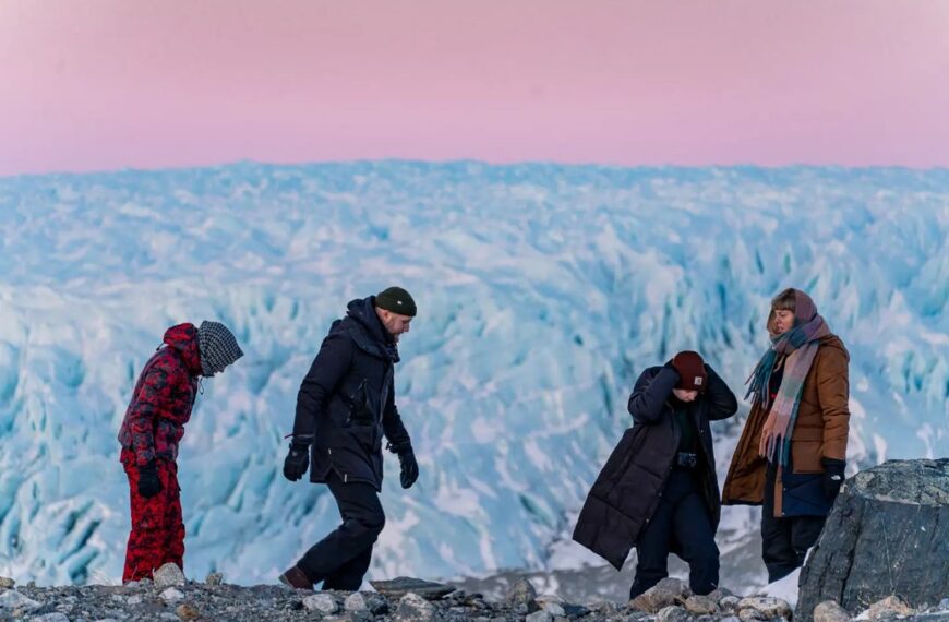 Guests on the moraines at the edge of the Greenland Ice Sheet at dusk - near Kangerlussuaq, West Greenland