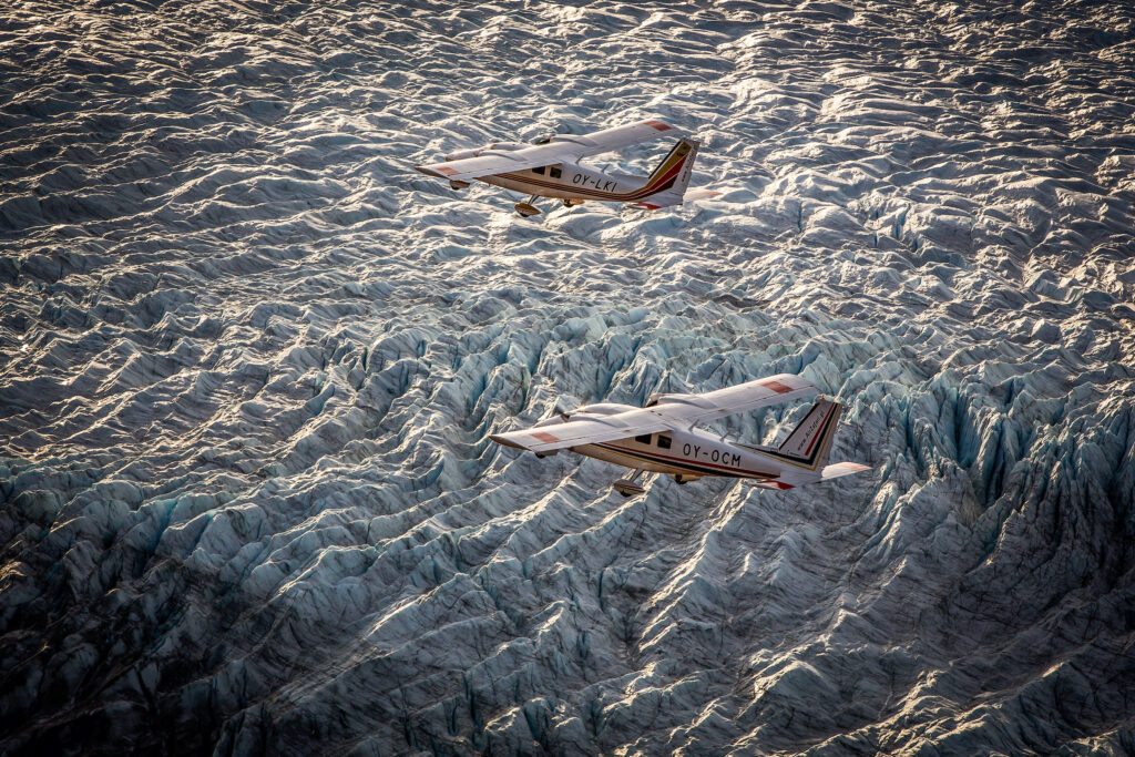 Two Air Zafari planes flying over the Greenland Ice Sheet near Kangerlussuaq, Greenland