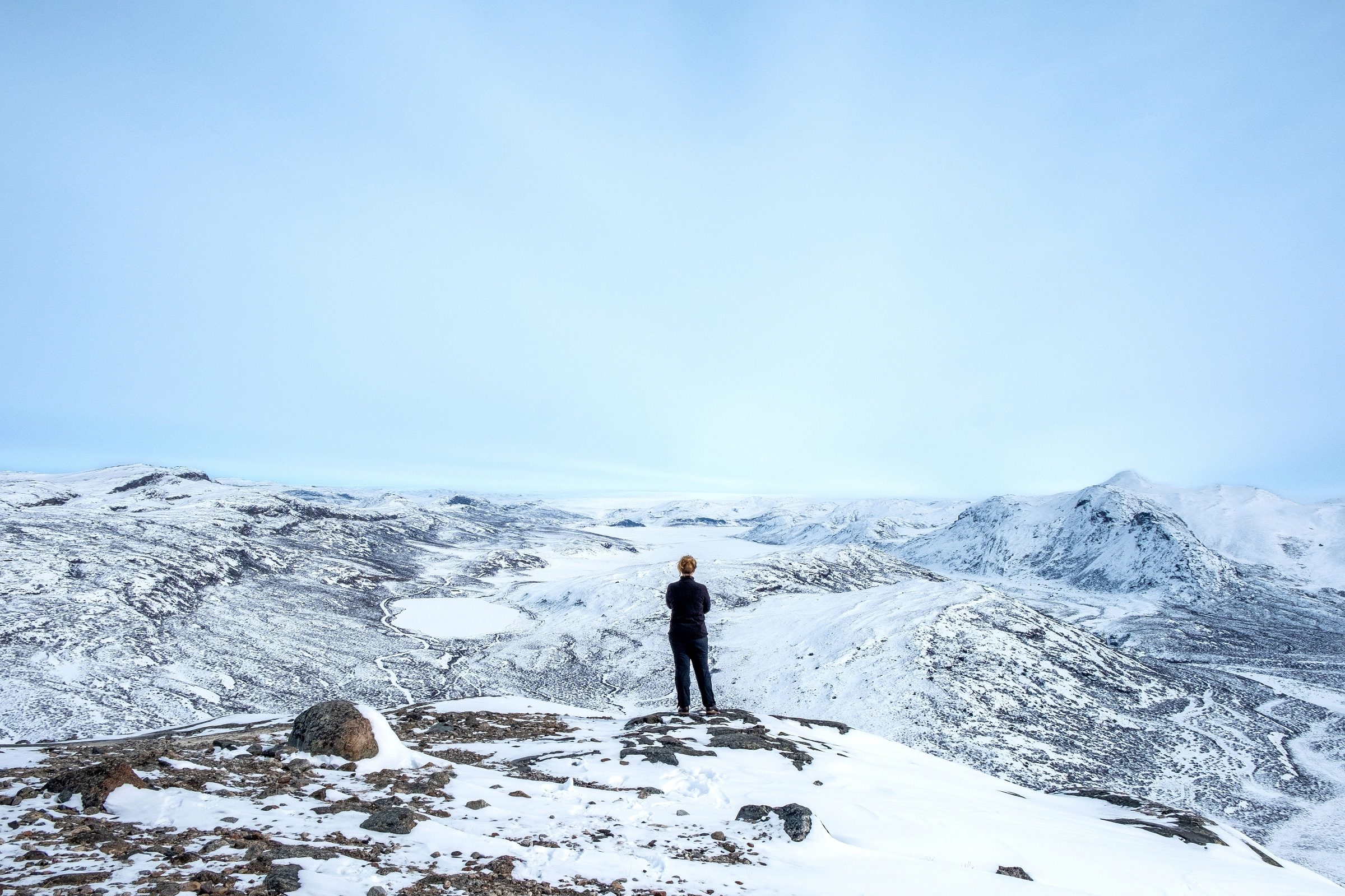 Winter hiker on top of Sugarloaf Mountain near Kangerlussuaq, West Greenland