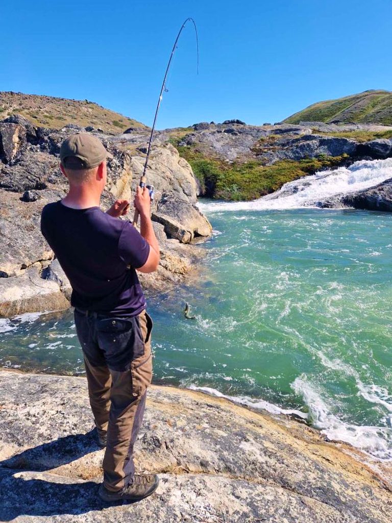 Person fishing on the Robinson River near Kangerlussuaq