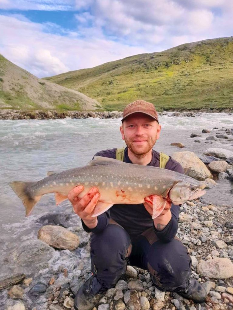 Fisherman holding his catch at Robinson River