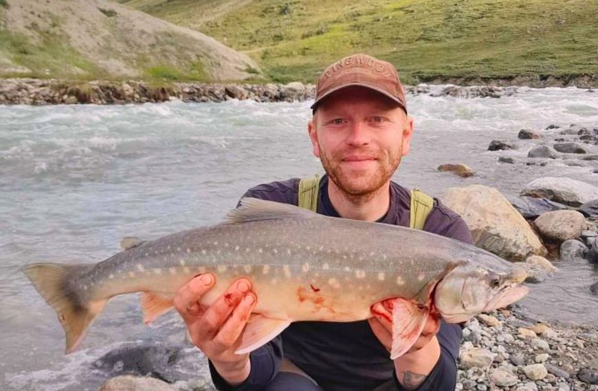 Fisherman holding his catch at Robinson River