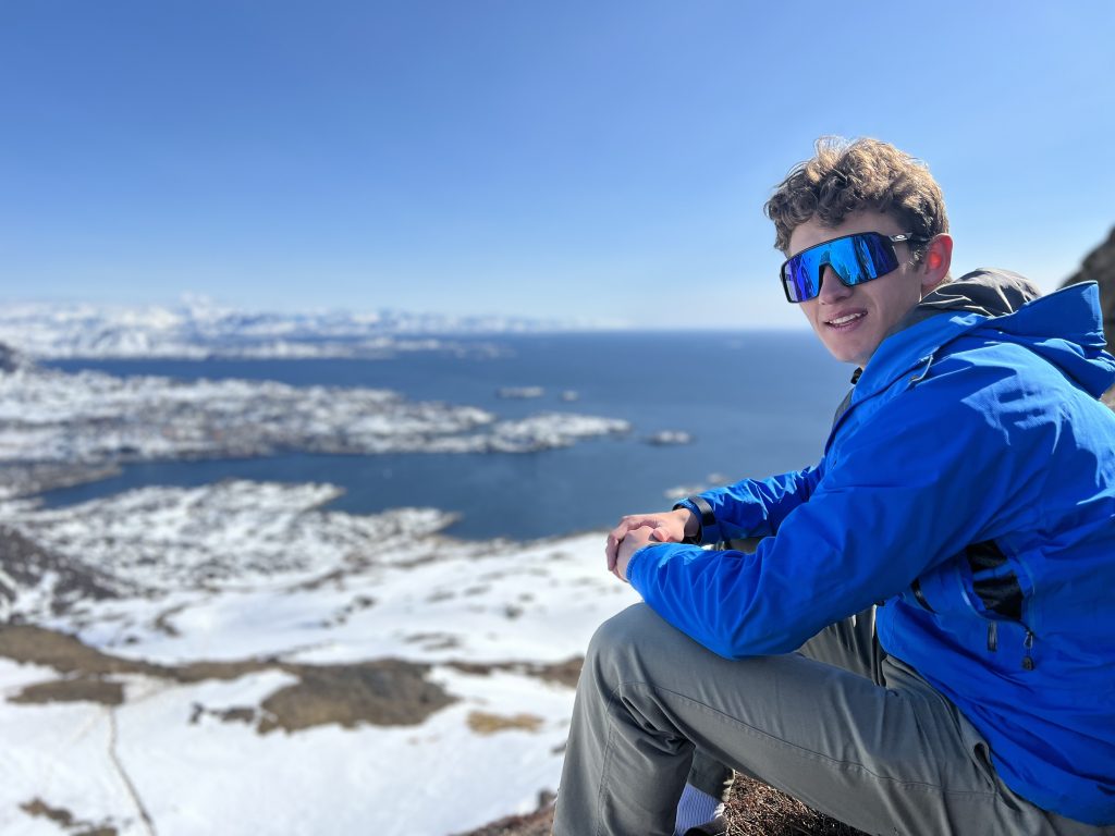 Hiker at the top of Palasip Qaqqaa in the spring