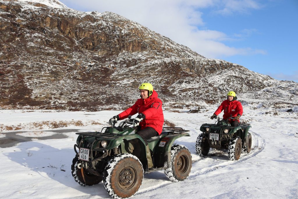 2 people on ATVs in the autumn backcountry near Sisimiut