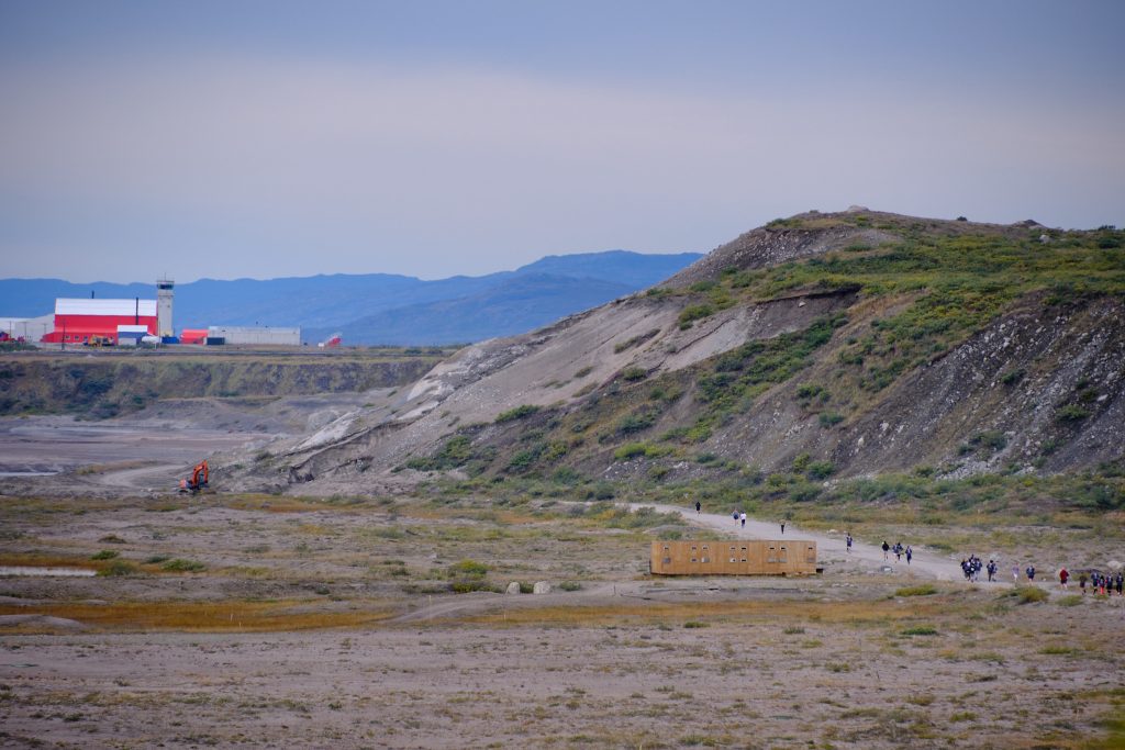 Distant shot of runners on the road and Kangerlussuaq in the distance