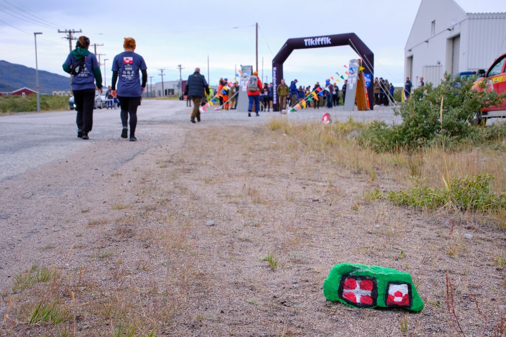 The finish line of Running of the Muskox with the last painted rock and some late finishers