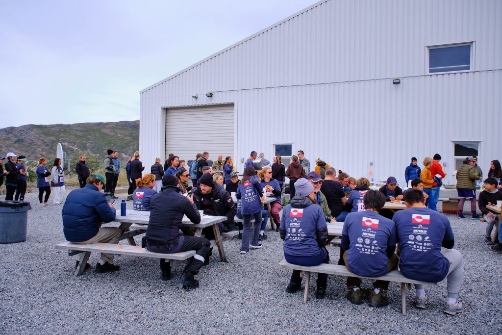 People eating at the post-race BBQ