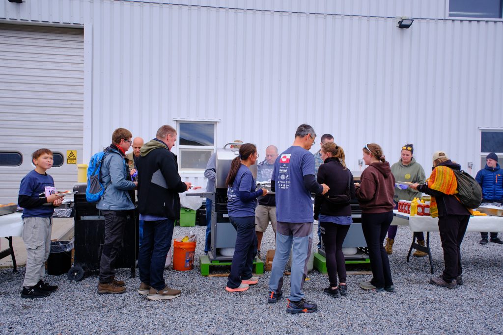 People lining up for BBQ sausages and hamburgers at the end of the race